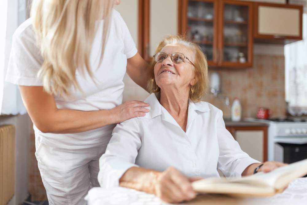 Nurse taking care of an elderly woman.