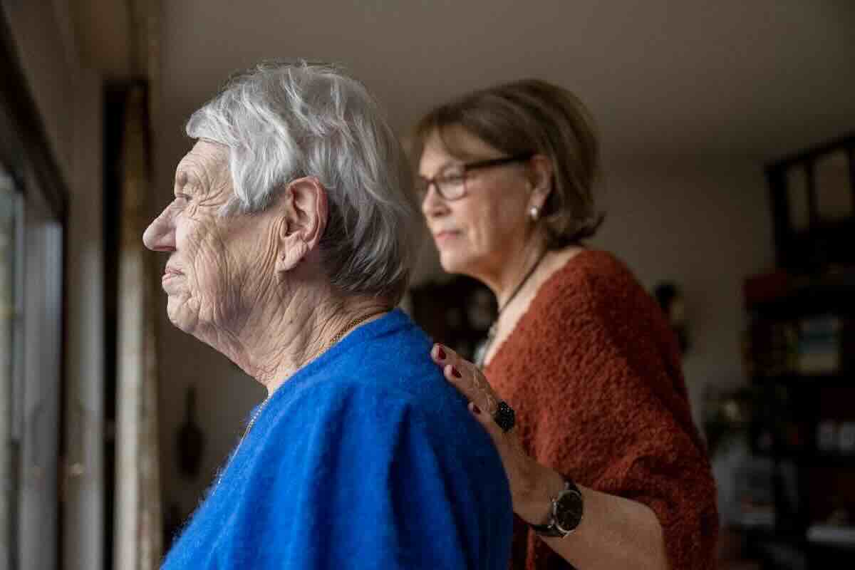 Elderly woman wearing blue facing the window while receiving hospice respite care.