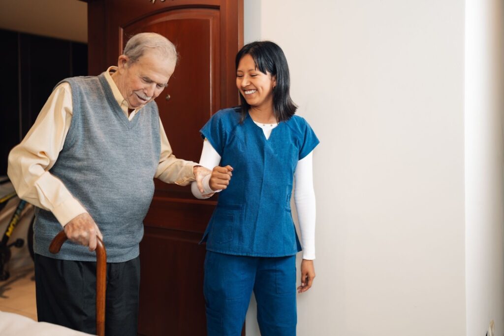 Aide assisting a man asking, “What do home health aides do?”